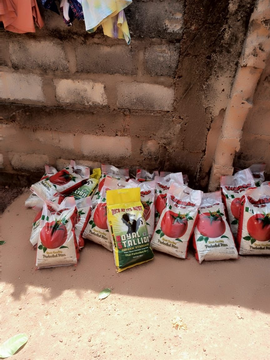 Bags of parboiled rice from the founder's foodstuffs business, lined up and ready to be distributed