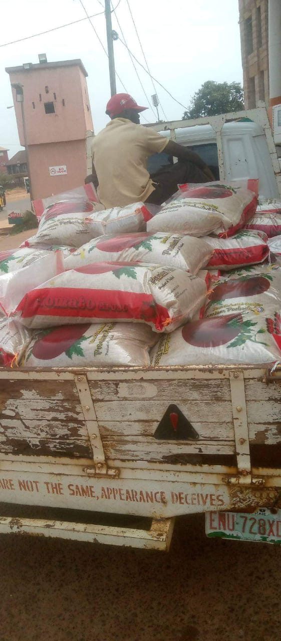 A truck loaded with bags of rice arriving for a distribution